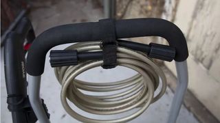 Close up of the RYOBI RY14122 hose tied up around the handle