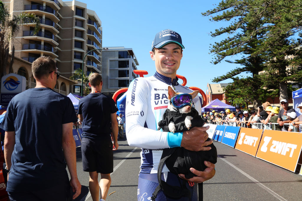 ADELAIDE, AUSTRALIA - JANUARY 24: Robert Stannard of Bahrain Victorious with Rider the dog at the start of stage 4 in Glenelg during day seven of the 2025 Tour Down Under on January 24, 2025 in Adelaide, Australia. (Photo by Sarah Reed/Getty Images)