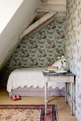 Small French-style bedroom with ornate wallpaper