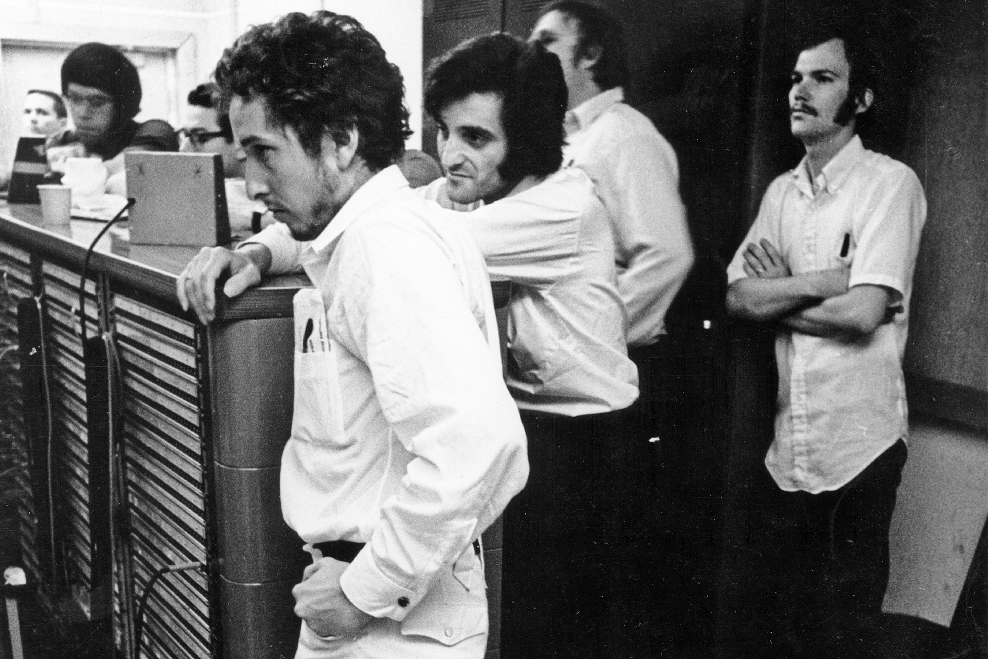 Bob Dylan listens intently in the recording booth during the recording of his album 