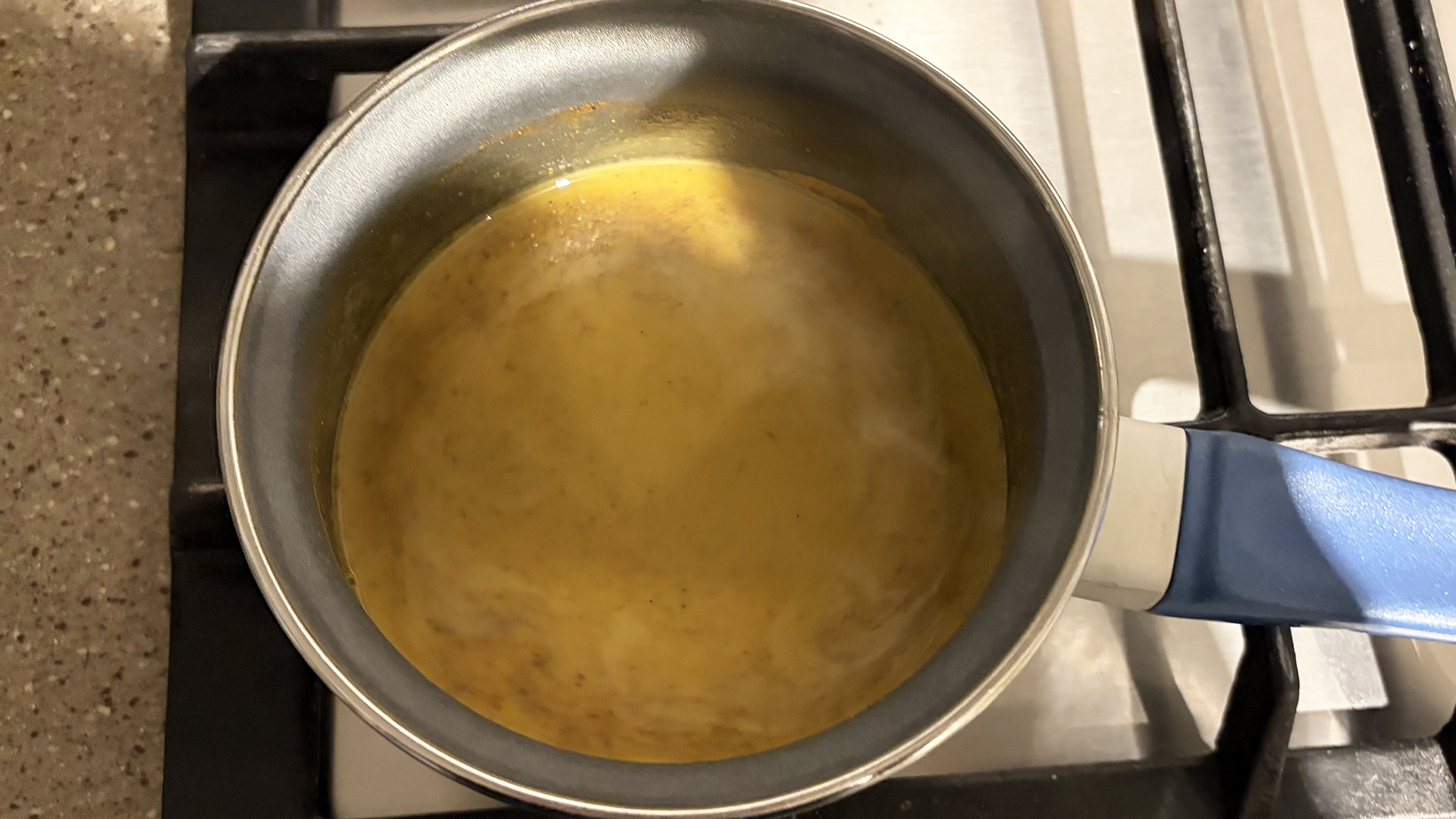 A pan of golden milk on a stove
