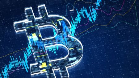 Bitcoin logo in front of a chart
