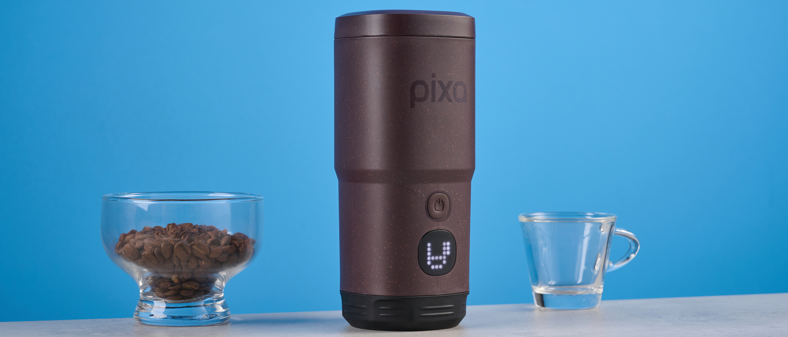 the wacaco pixapresso portable self-heating espresso maker in dark purple color showing usability with nespresso pods and ground coffee, ideal for vacations and camping