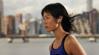 A person wearing Apple AirPods 3 in the rain.