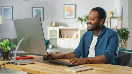 A person using a desktop computer.