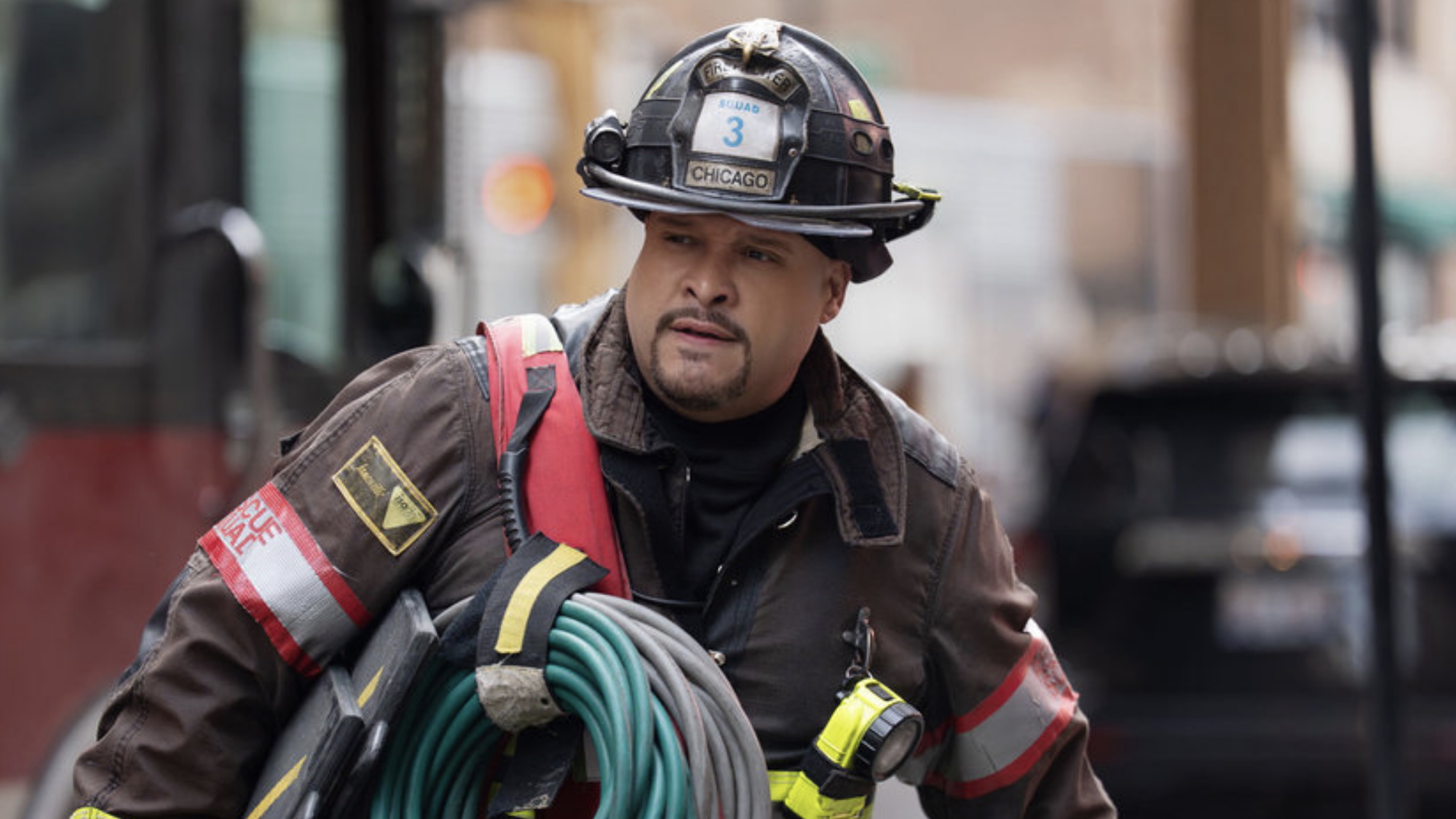 Cruz in full uniform in front of a bus in Chicago Fire Season 14