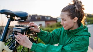 Woman fitting an e-bike battery