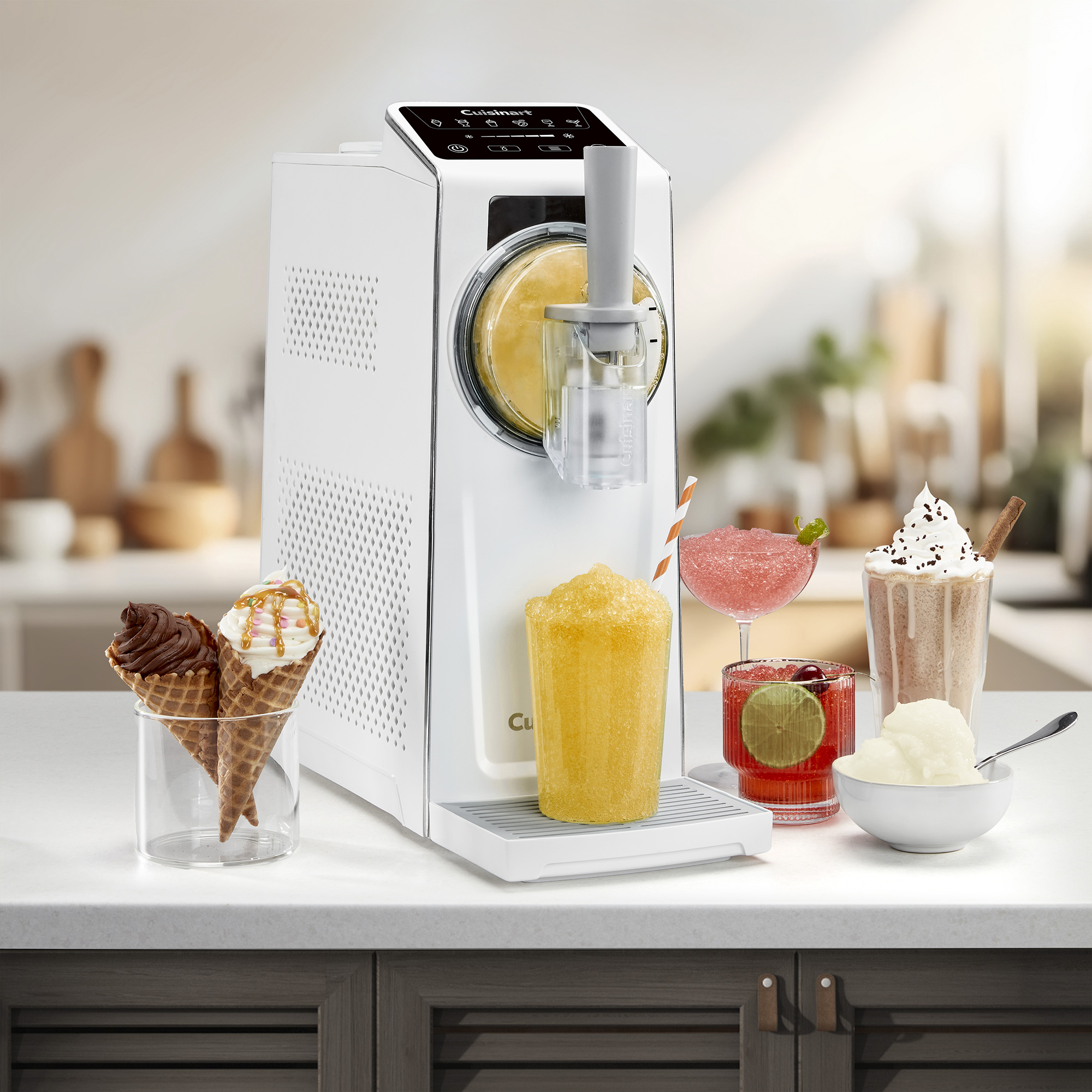 Cuisinart slushie and soft serve machine with various drinks and ice creams around it in a promotional image 