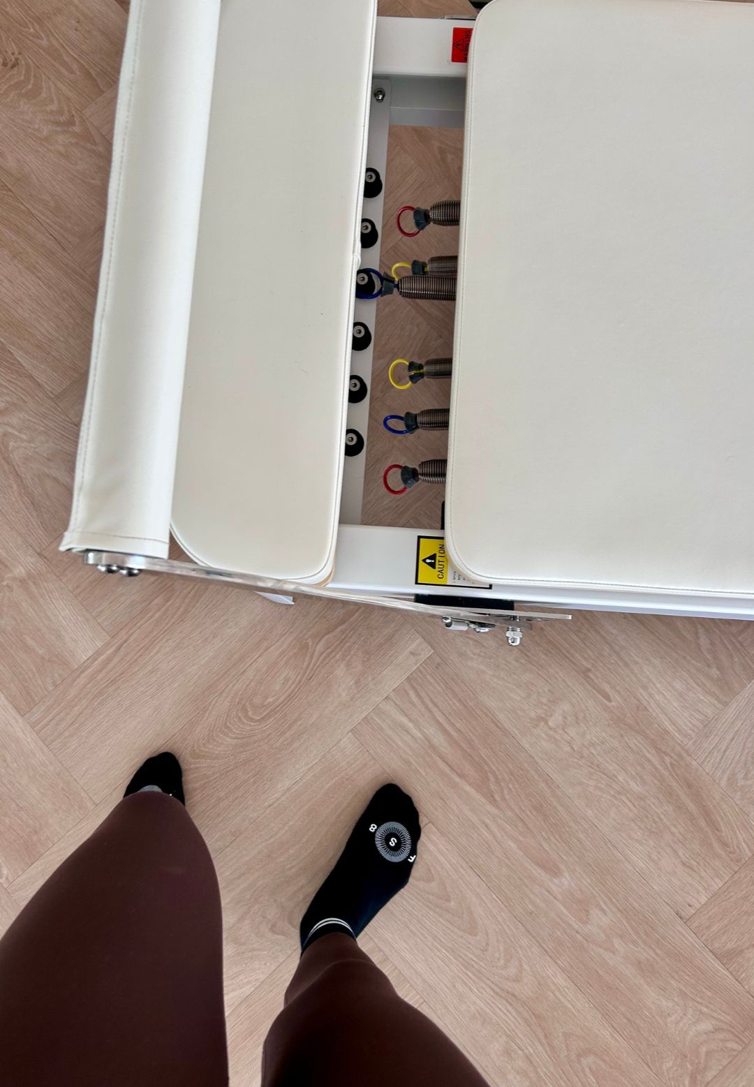A Reformer Pilates machine and Becks' socks in a studio during her pregnancy Reformer session