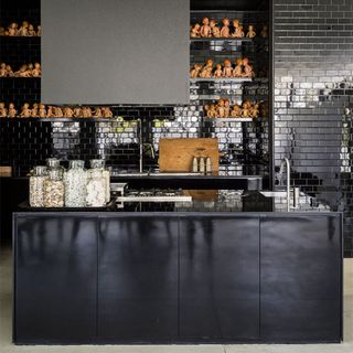 kitchen with black kitchen counter and black brick tiles wall