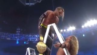 Jeff Hardy celebrates while Edge is stuck in the ladder at Extreme Rules 2009