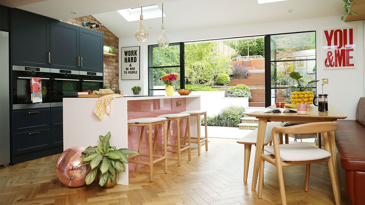 kitchen diner with pink island and stools