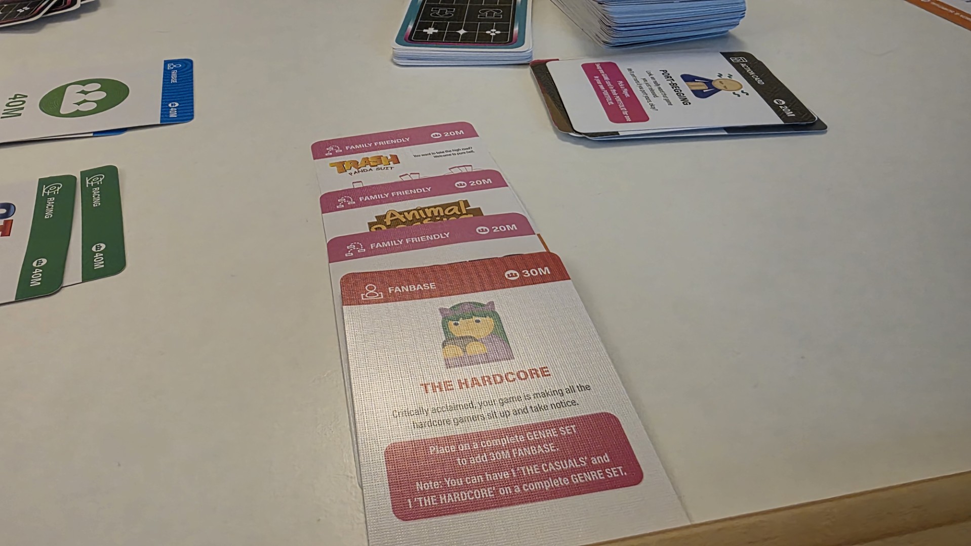 Cards from Console Wars the game laid out on a table during a game