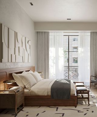 White bedding on a bed against a wall with floor-to-ceiling windows.