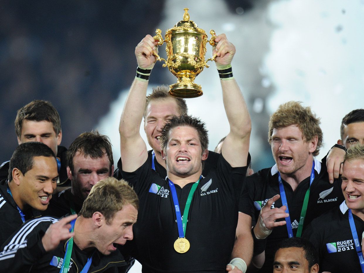 New Zealand All Blacks captain Richie McCaw holds the Webb Ellis cup together with the players after the 2011 Rugby World Cup final match New Zealand vs France at Eden Park Stadium in Aucklan