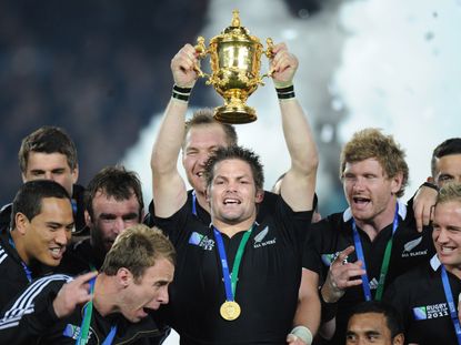 New Zealand All Blacks captain Richie McCaw holds the Webb Ellis cup together with the players after the 2011 Rugby World Cup final match New Zealand vs France at Eden Park Stadium in Aucklan