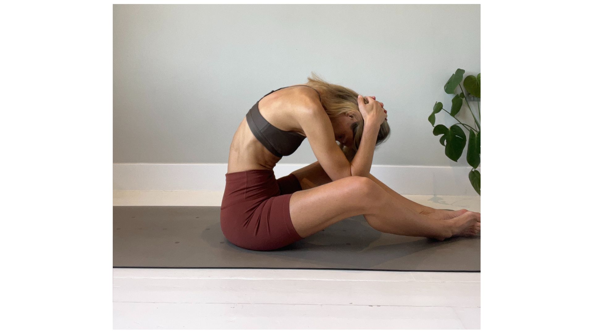 Shape Pilates founder Gemma Folkard demonstrating a spine stretch forward