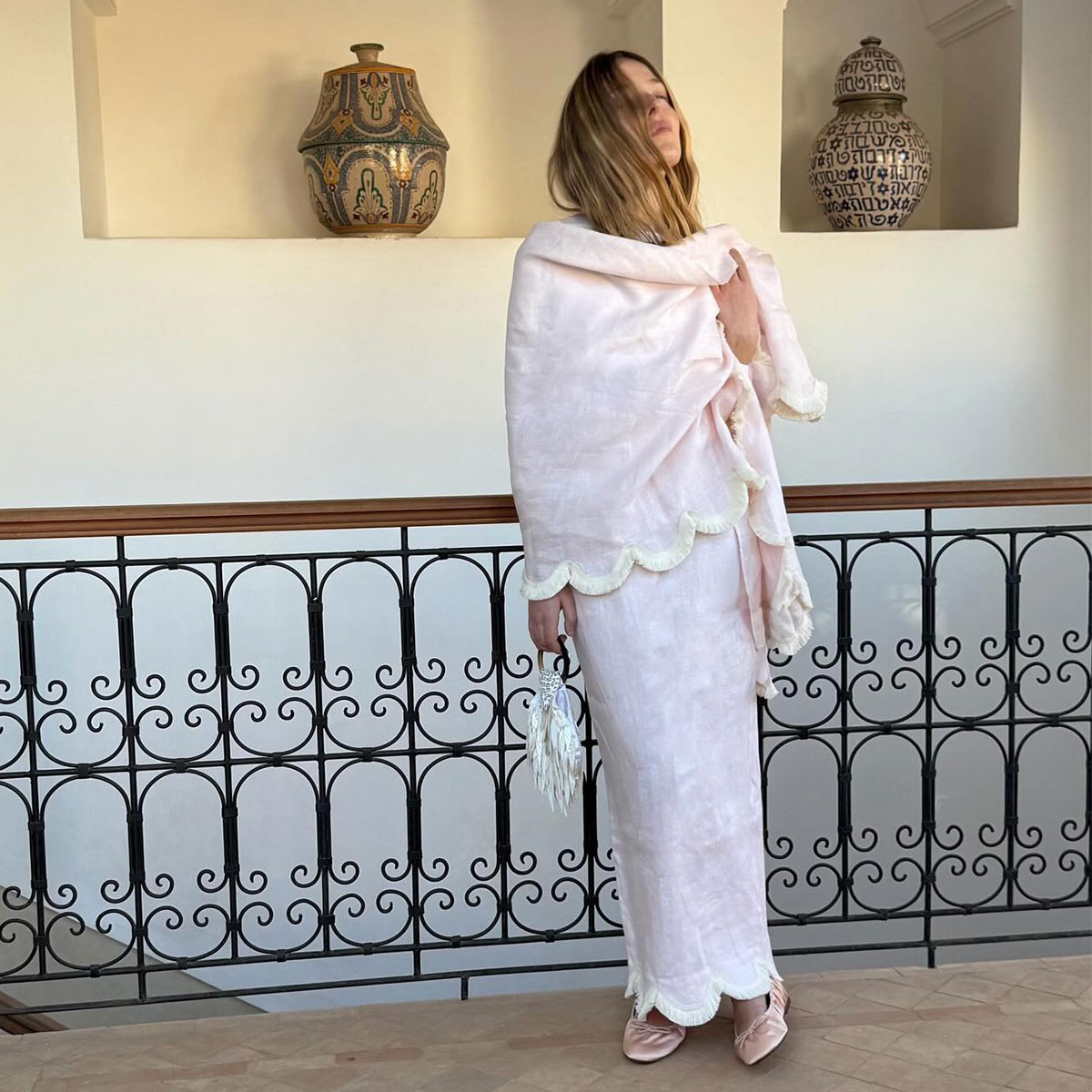 @silviadusci posing in pale pink posse brand fringed wrap matching skirt