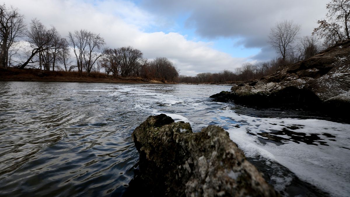 Water flows into the Minnesota River from a pipe connected to the Blue Lake treatment plant in Shakopee, Minnesota.