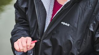 Alpkit Haven changing robe being worn on a river bank