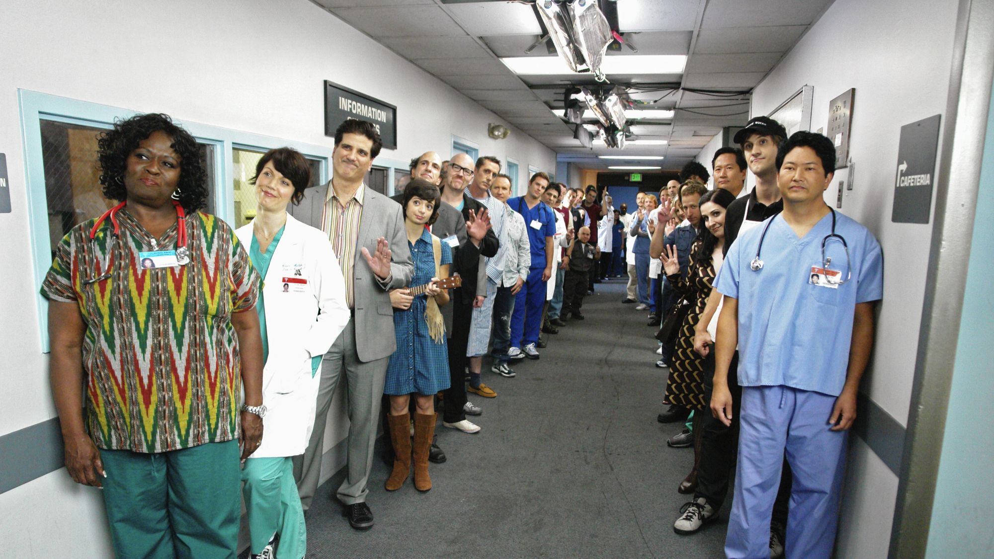 Cast of Scrubs lined up in a hallway