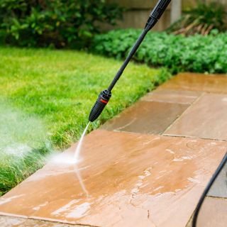 pressure washer cleaning patio