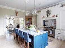 Kitchen with blue kitchen island and flowers