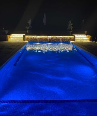 pool with waterfall and steps with lighting by Tanby Pools