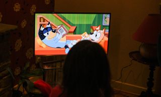 Young child watching Bluey on television