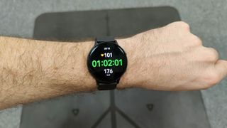 Samsung Galaxy Watch Active 2 review: watch worn on wrist photographed over a weight bench
