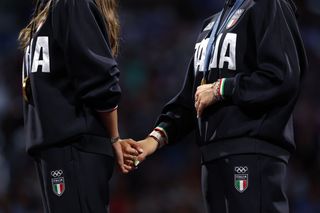 olympic athletes holding hands