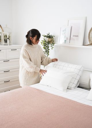 Woman making bed