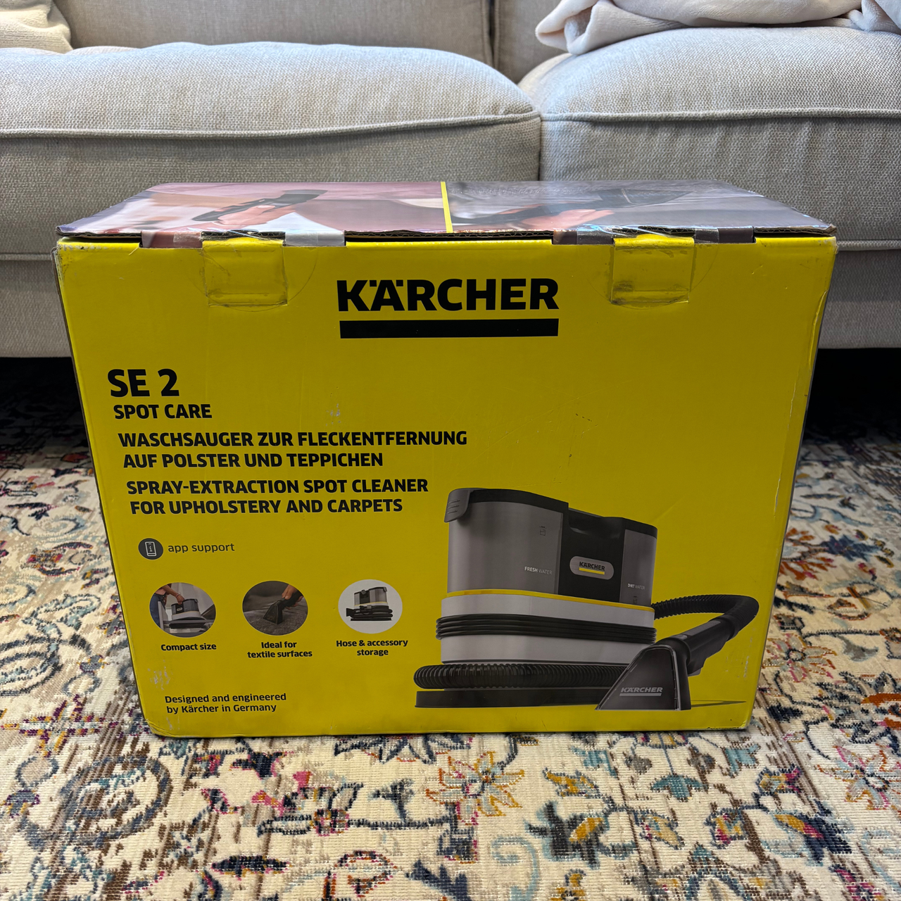 Karcher SE 2 Spot Cleaner in yellow branded cardboard box placed on rug