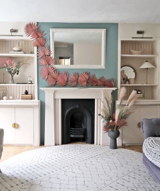 A living room with a painted fireplace, which is surrounded by bookshelves made with Ikea products