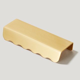 A scallop edge brass pull
