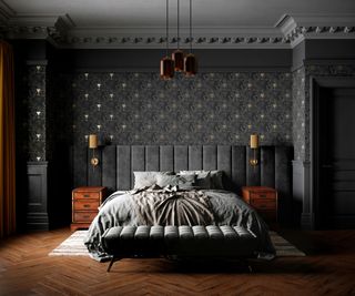 dark grey bedroom with patterned wallpaper, dark wooden flooring and grey bedcovers