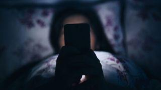 Woman on her phone in bed