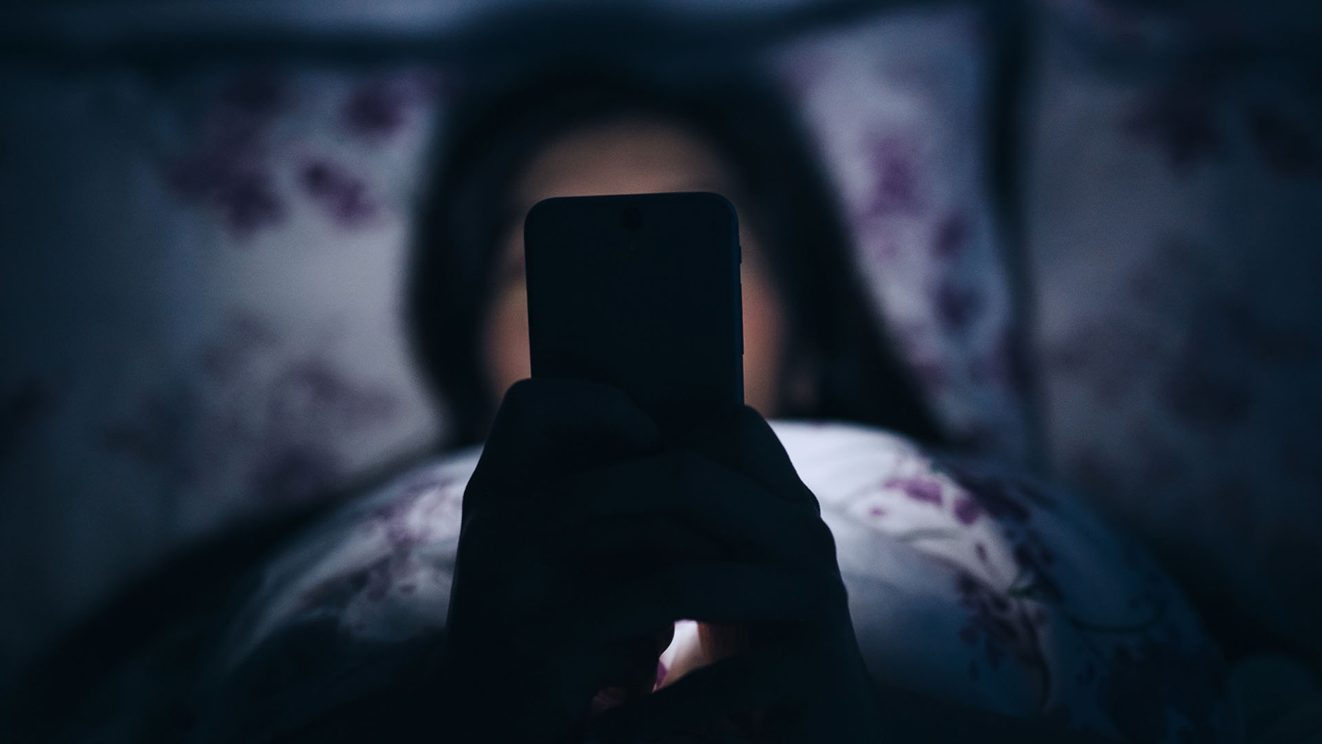 Woman on her phone in bed