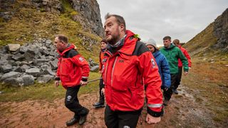 Mountain rescue carrying a stretcher