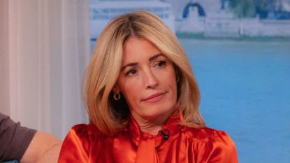 Cat Deeley wearing red shirt and brown suit trousers on This Morning on 22 Sep 2025