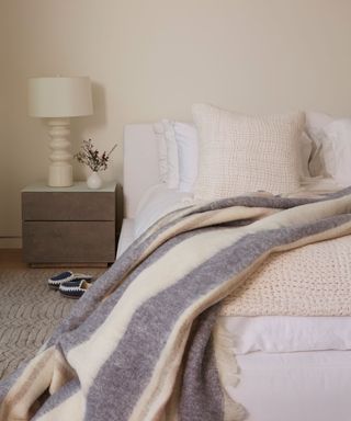 neutral bedroom with blanket and pillows