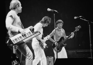 Czech-American musician and composer Jan Hammer playing keyboards supported on a shoulder strap, British guitarist and songwriter Jeff Beck, wearing a white t-shirt with white trousers, and an unspecified musician playing the bass guitar at the Ronnie Lane ARMS Benefit Concert at Madison Square Garden in New York City, New York, 8th December 1983. The concert is one of a series of ARMS charity concerts being staged in support of Action into Research for Multiple Sclerosis. (Photo by Vinnie Zuffante/Michael Ochs Archives/Getty Images)
