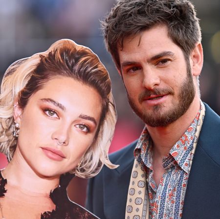 Andrew Garfield holding a cardboard cutout of Florence Pugh on the red carpet