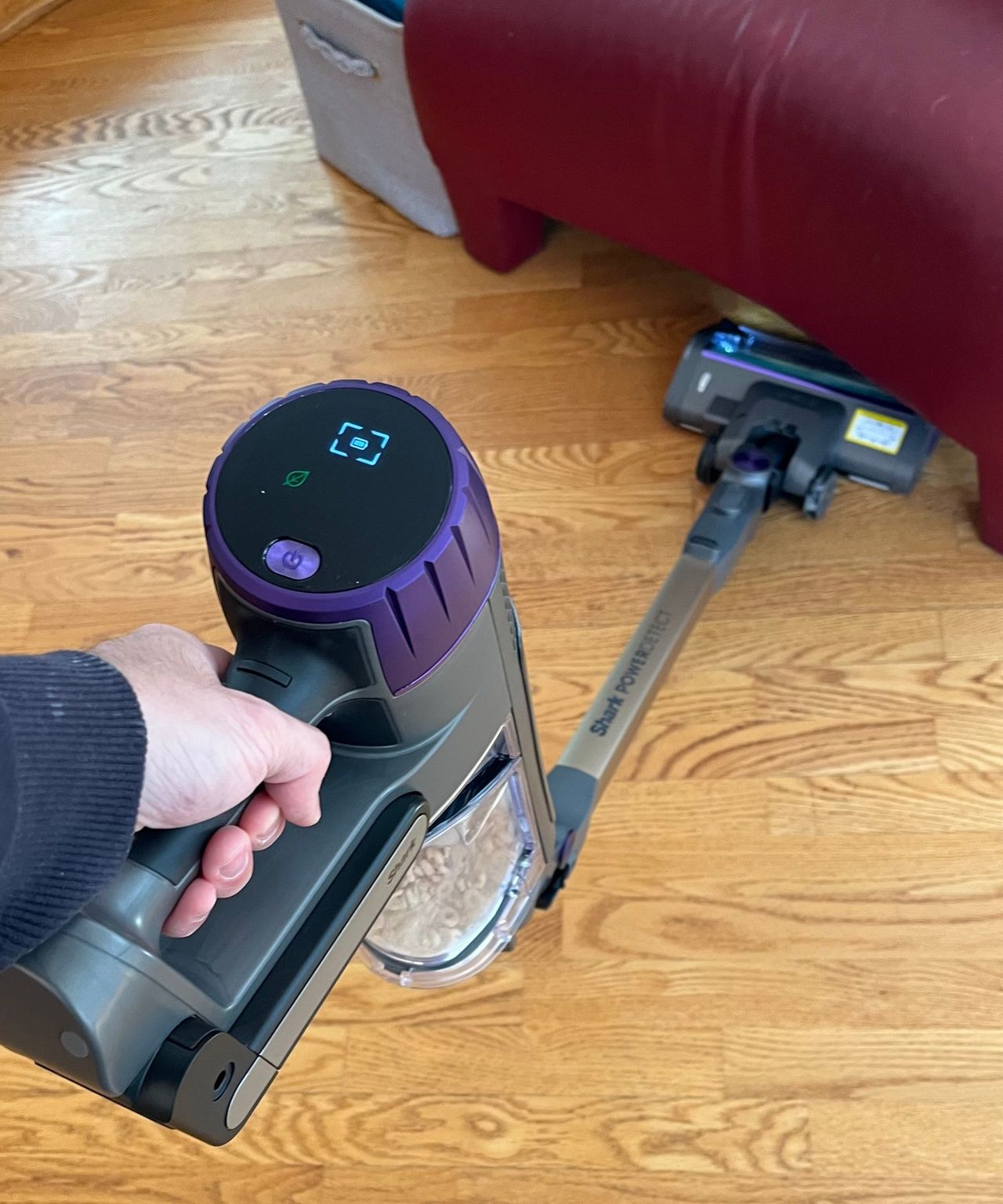 Shark Cordless PowerDetect vacuuming a wooden floor using the folded telescopic tube during testing in James' home