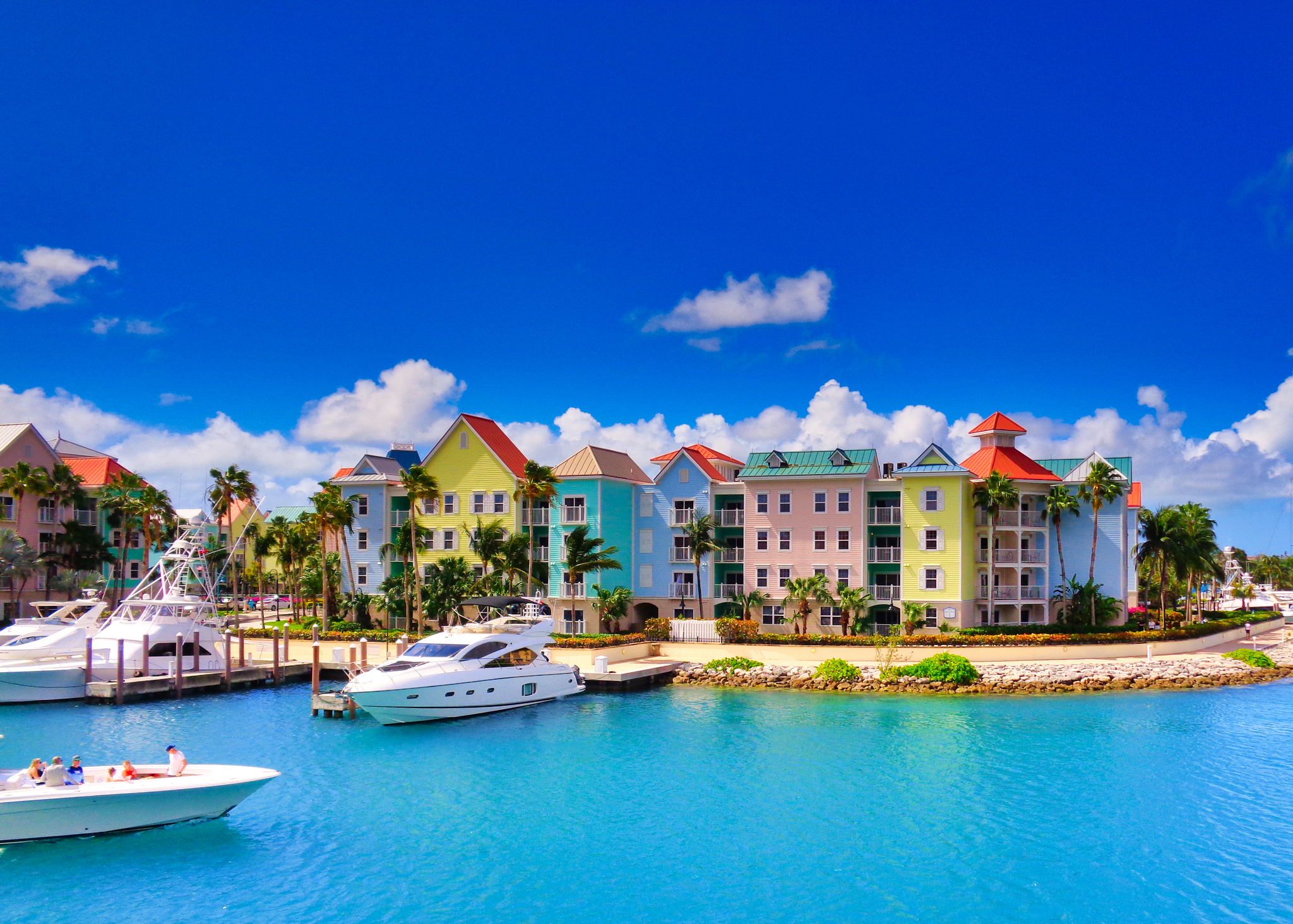 View of Nassau against a bright blue sky and ocean with boats in the harbor