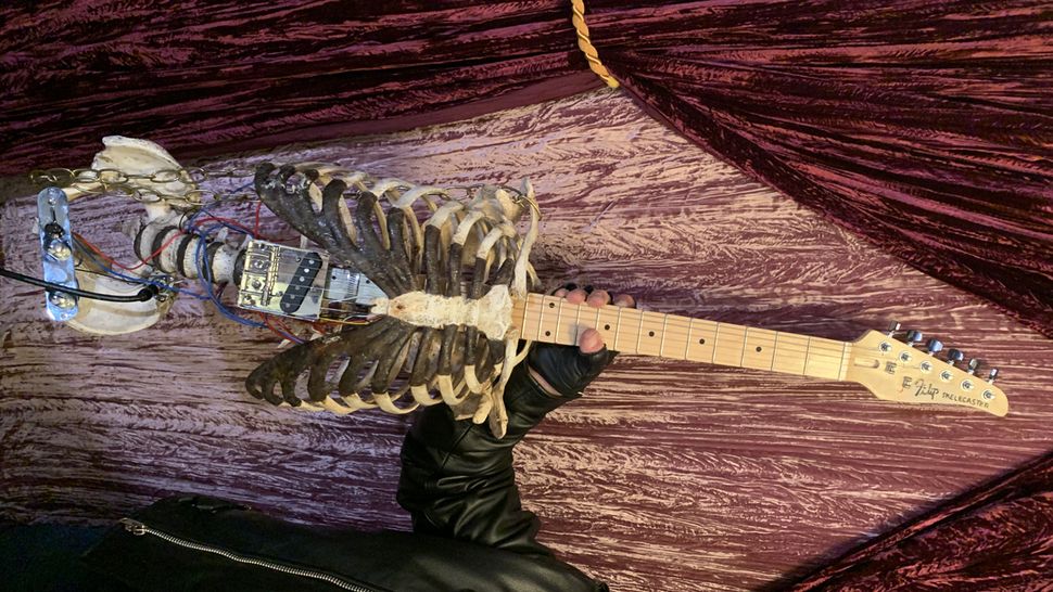 Man builds guitar out of uncle’s skeleton, uses it to play black metal