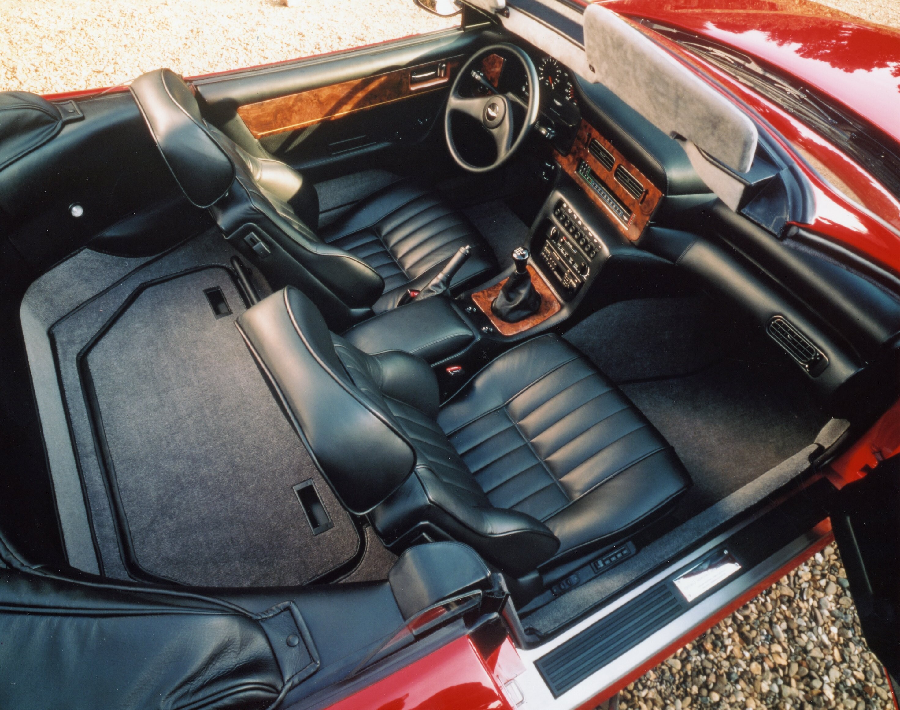 Details of the V8 Vantage Volante, showing the interiors, the engine and the front and rear of the car