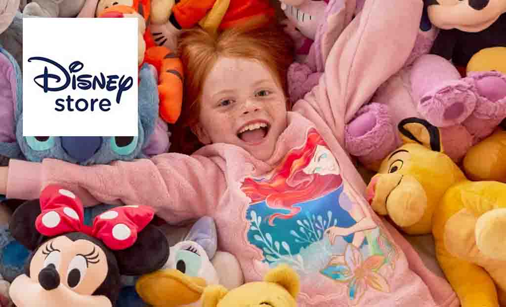 Disney Store logo placed over an image of a girl smiling amongst teddies and plushies of iconic characters