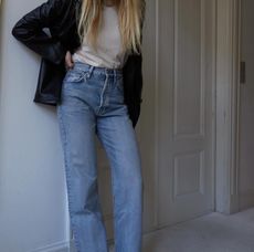 woman in black leather blazer white shirt and jeans
