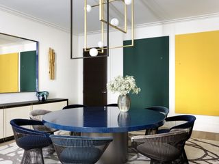 Green and yellow rectangle wall hangings, blue circle dining table